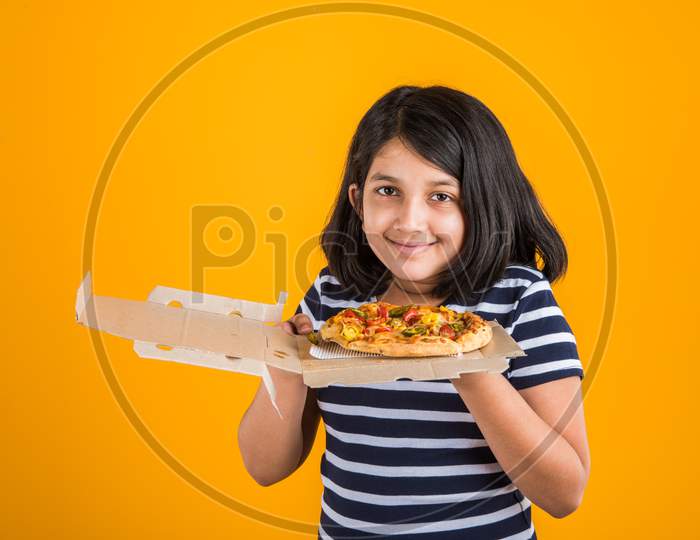 Cute little girl eating pizza