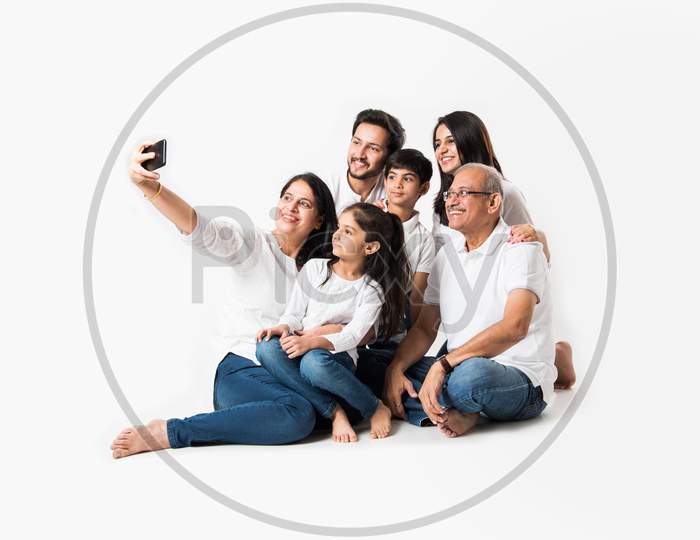 family taking selfie picture white sitting on white background