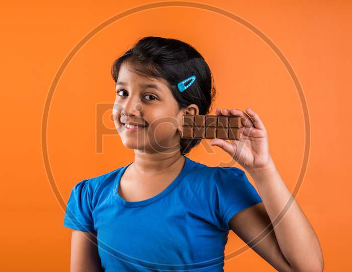 Small girl eating chocolate