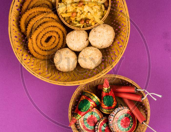 diwali food / snacks /sweets with fire crackers isolated