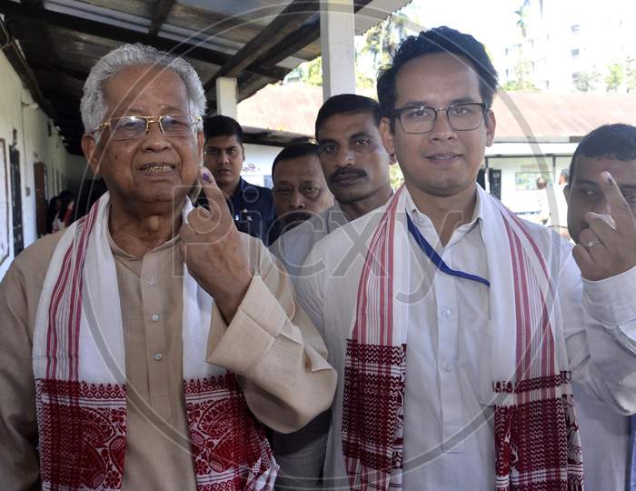 Former Assam Chief Minister Tarun Gogoi and His son Gourav Gogoi shows their ink-marked finger