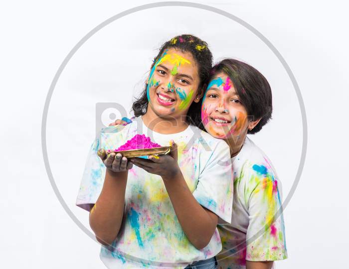 Kids playing with Holi colours