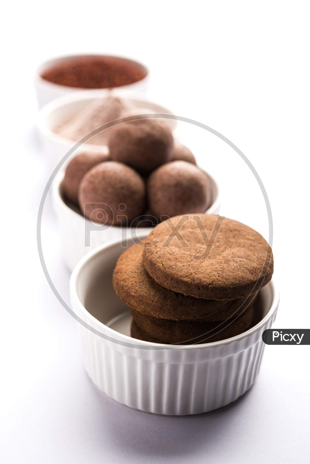 Image of Ragi or Nachni laddu and biscuits or cookies-SV495335-Picxy