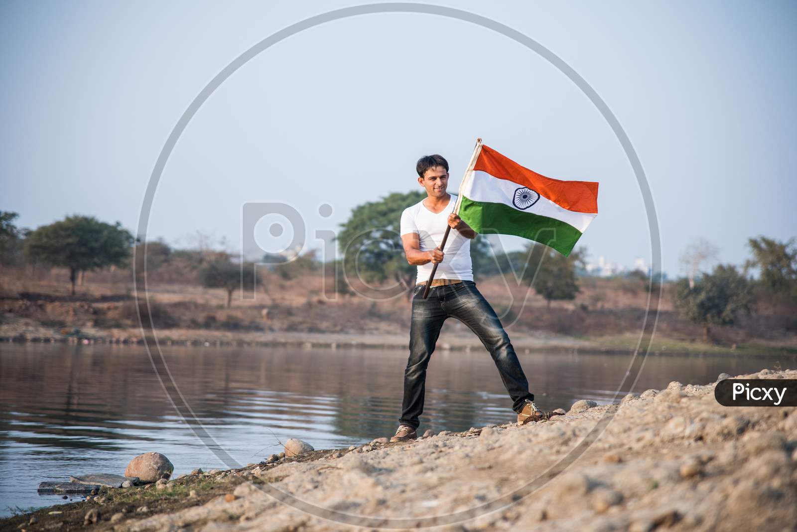 Handsome Indian Man holding national flag or Tricolour