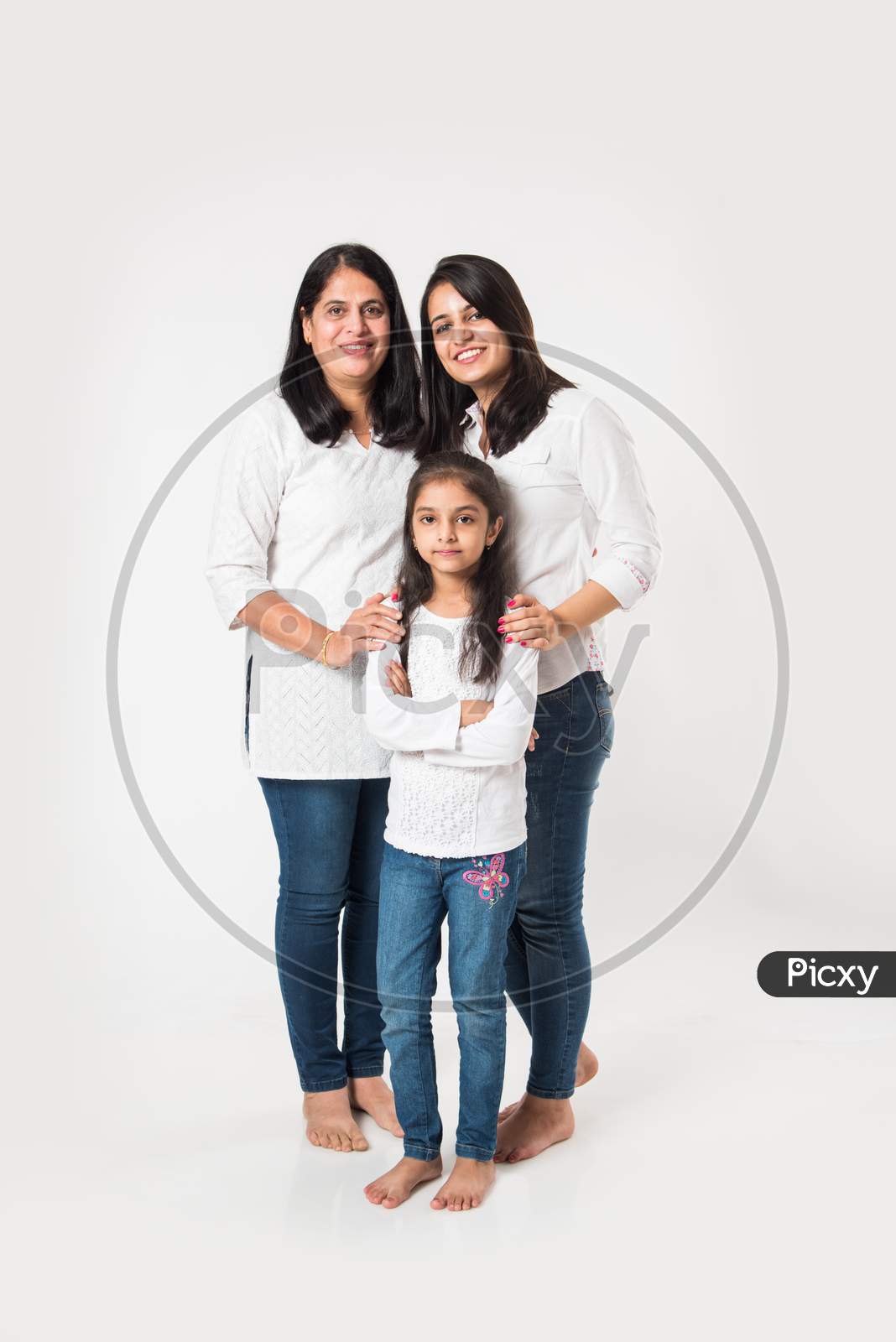three generations of females standing isolated over white background