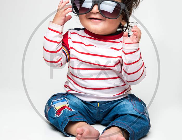 cute little Indian baby boy wears dark glasses
