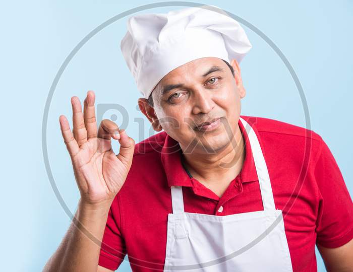 Indian Male Chef / cook in apron and wearing hat