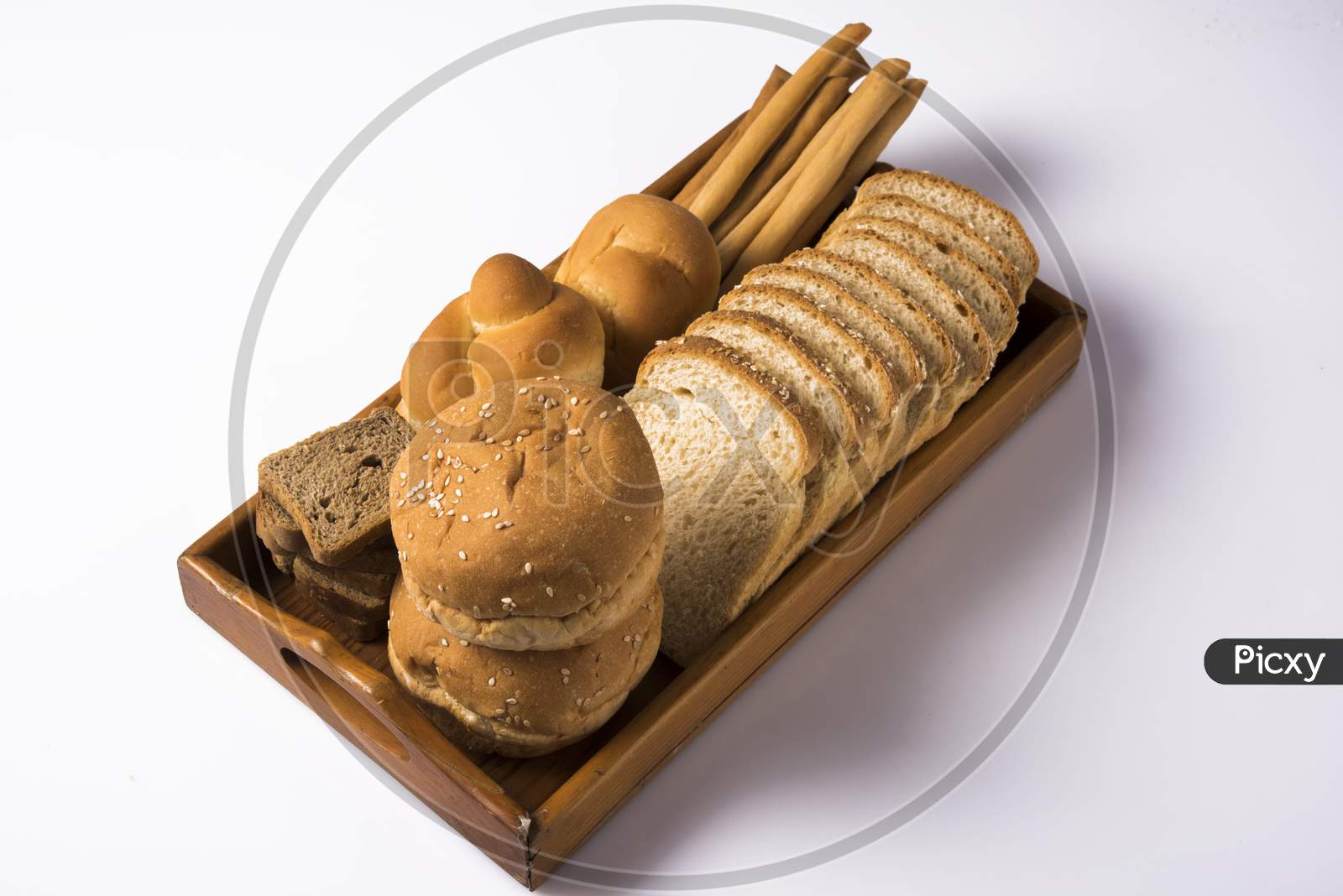 Variety of assorted fresh bread from bakery, served in a basket / tray