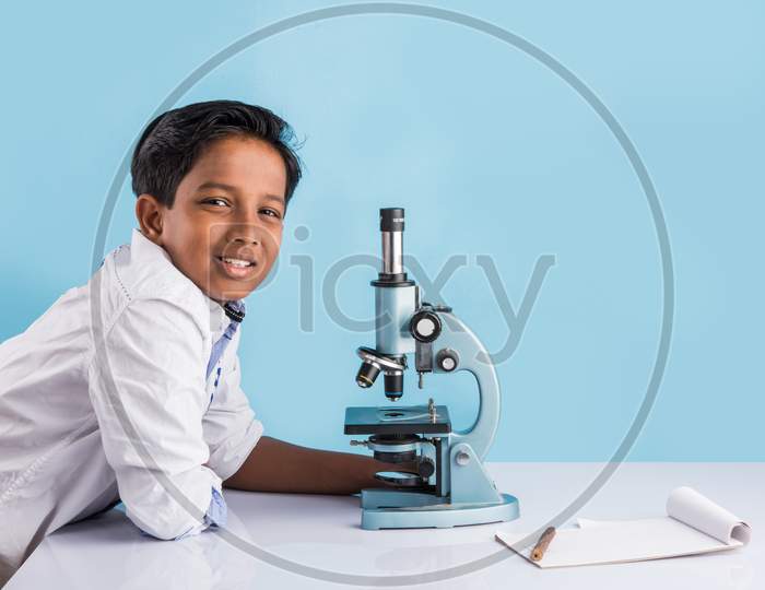 Cute little school girl studying science