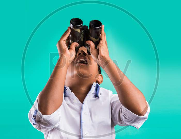 School kid looking through binocular