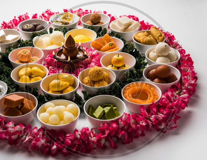 Flower Rangoli with sweets/mithai and diya