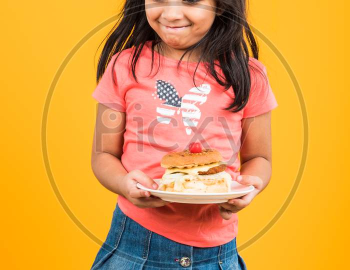 Cute little girl eating burger