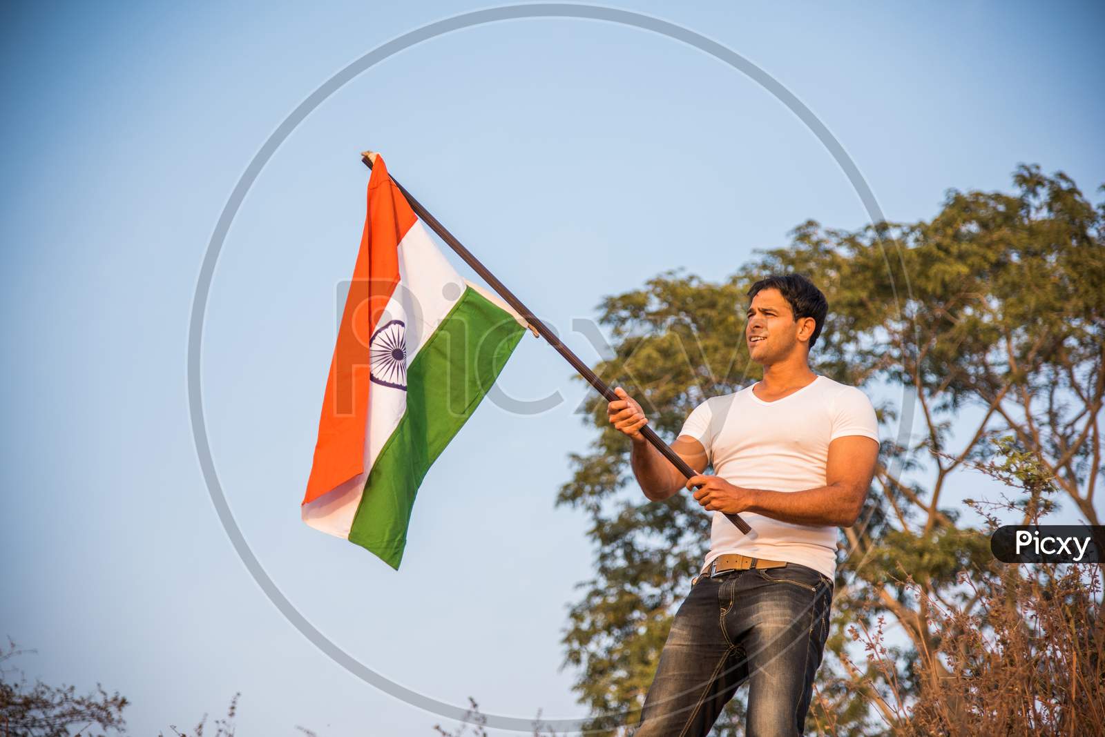 Handsome Indian Man holding national flag or Tricolour
