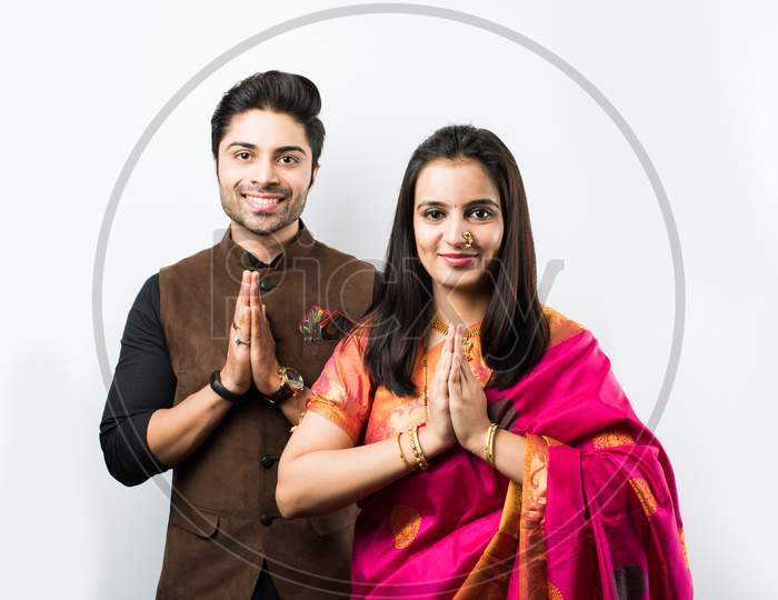 Indian couple in ethnic wear in namaskara pose or greeting