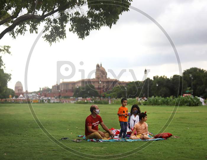 A family of four enjoys an outdoor picnic at Rajpath in New Delhi on July 08, 2020