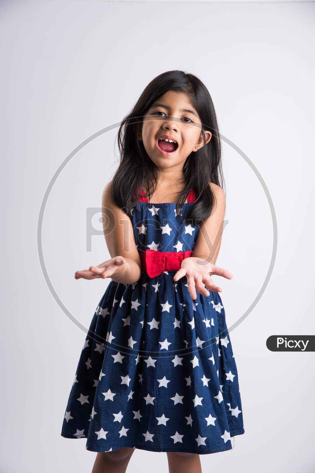 Indian cute girl with colourful palm over white background