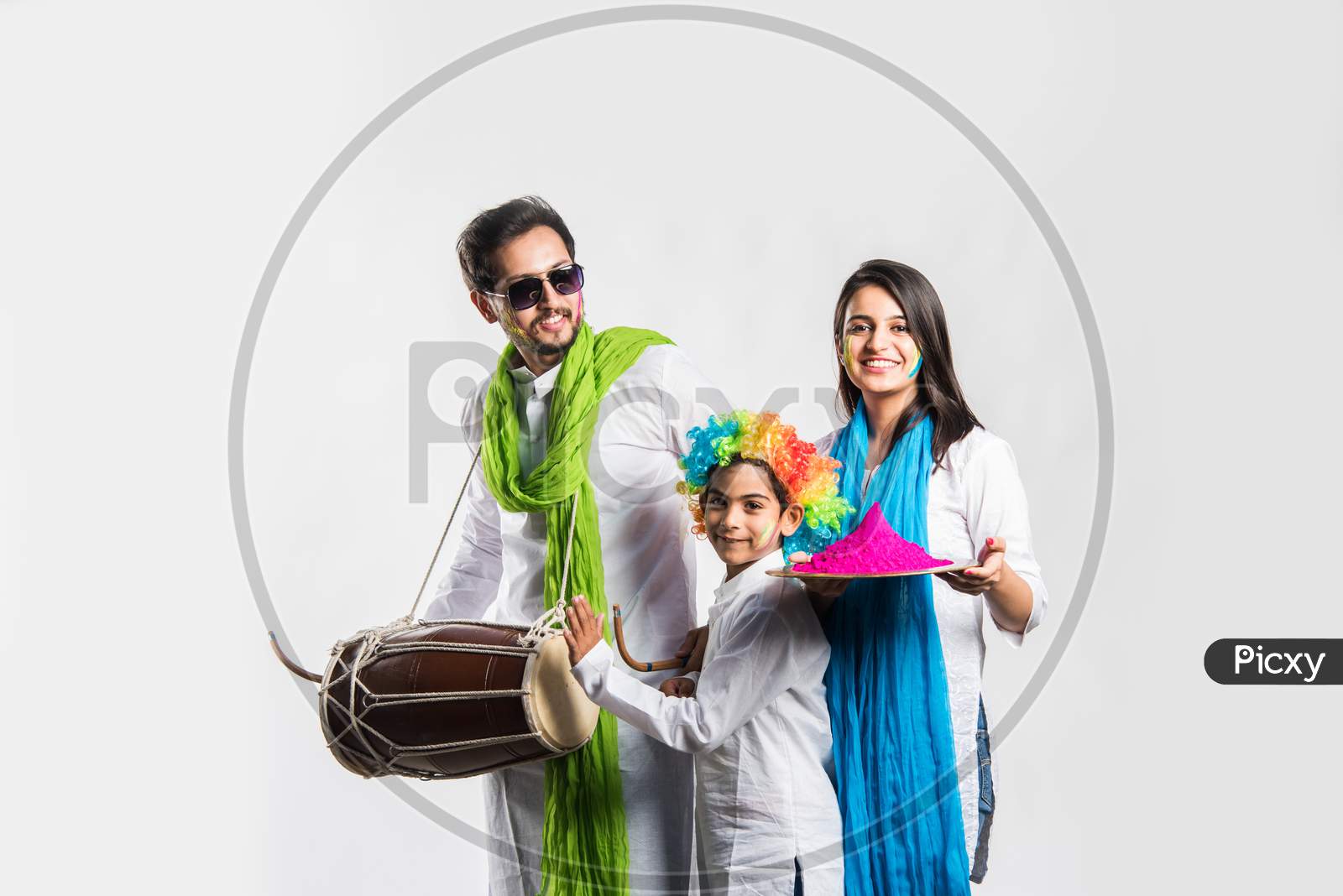 young couple with kid celebrating holi festival