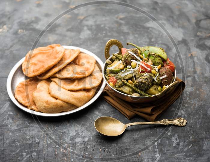 Undhiyu is a Gujarati mixed vegetable dish, specialty of Surat, India. Served in a bowl with or without poori