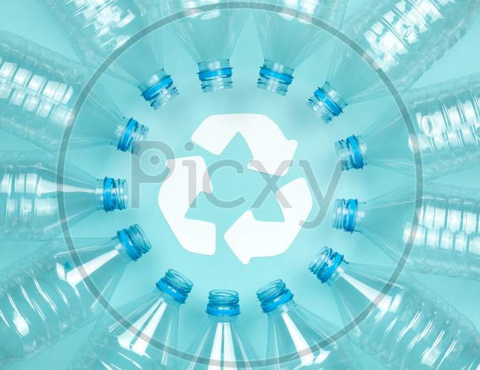 Clear Plastic Bottles Without Caps On A Blue Background. Recycling And Environment Concept.