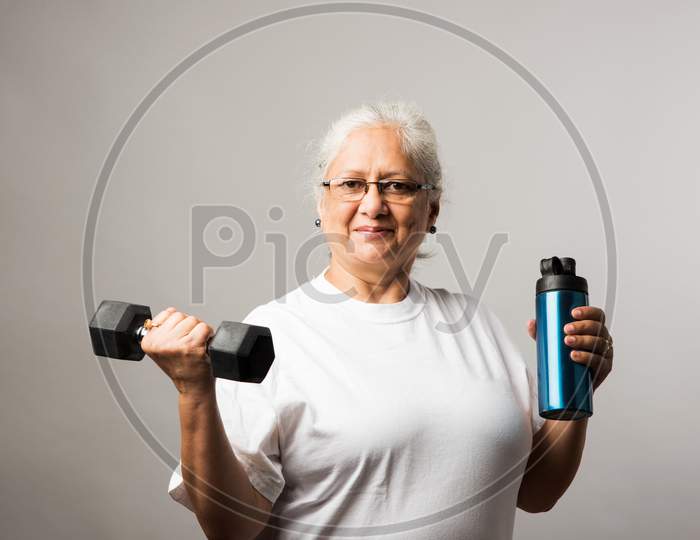 Senior Indian/asian lady exercising - Women Fitness and age concept