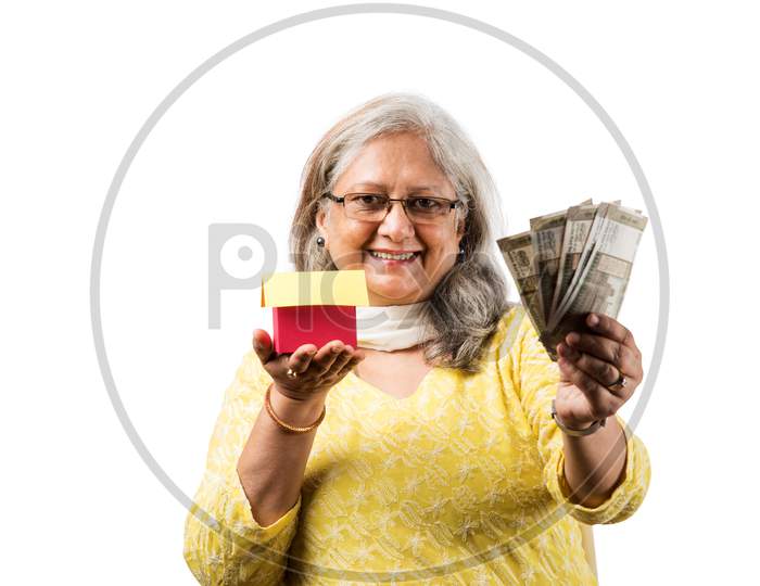 Senior woman and real estate concept with money