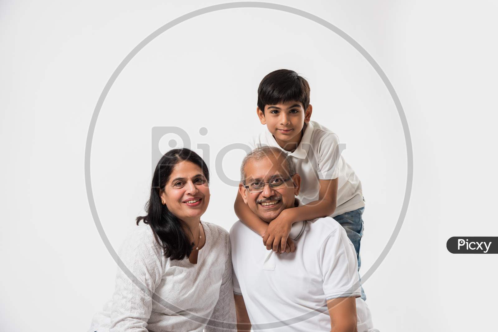 Indian senior couple with grandson, isolated over white