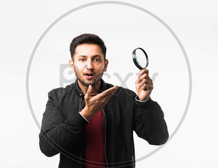 young man with magnifying glass