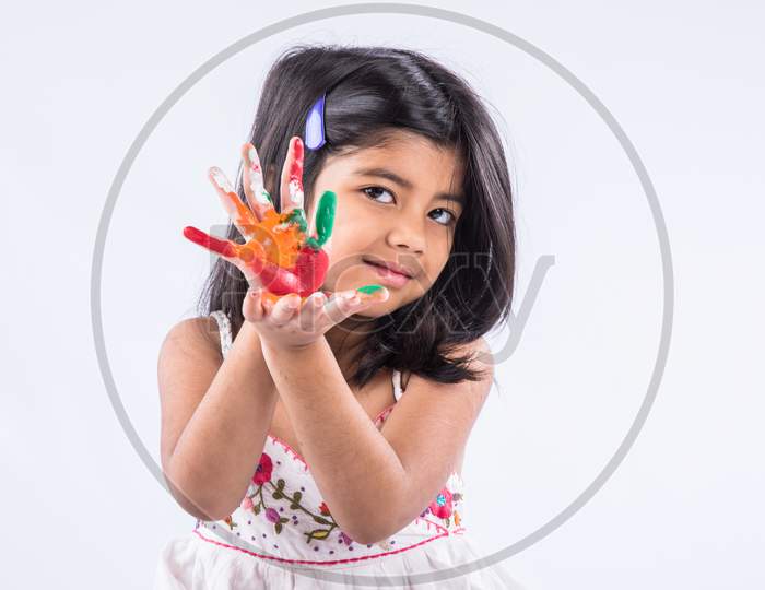 Happy Holi Greeting card showing cute little girl with hands painted