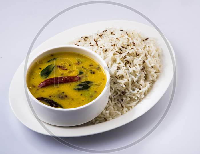 Whole Yellow Lentil dal tadka or fry with Jeera Rice, selective focus