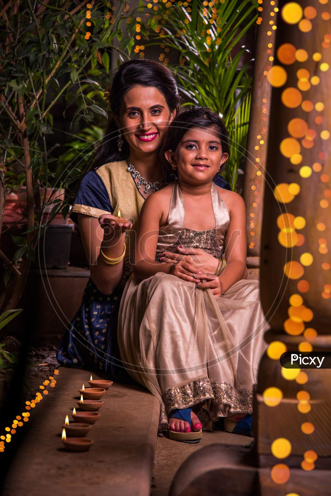 Indian mother and daughter celebrating diwali festival