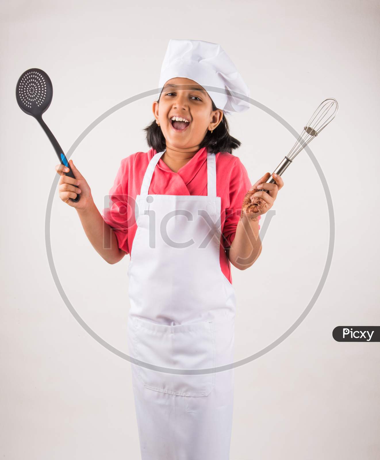 Small girl chef with hat and spatula