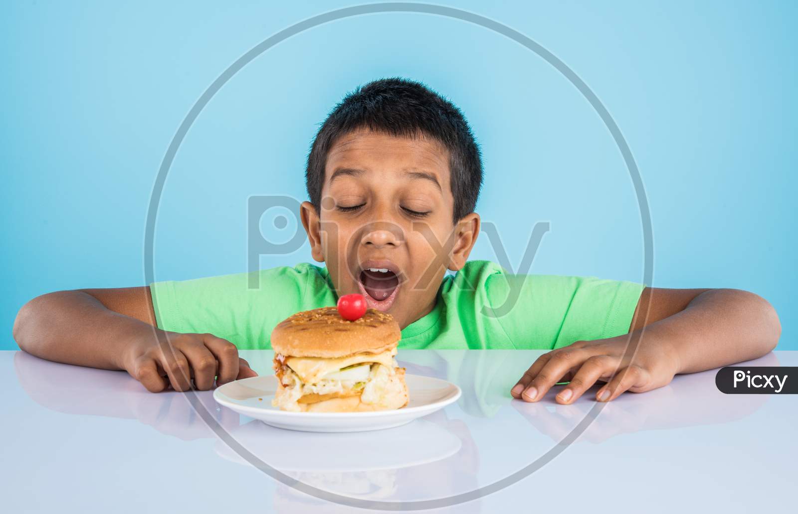 little boy eating burger