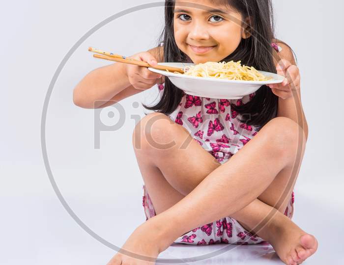 Small Girl eating chinese noodles
