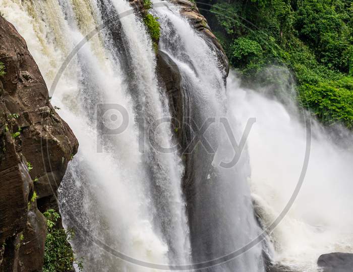 Beautiful Nature View During Mansoon Time With Full Filled Water Fall And Green Forest From The Famous Tourist Place In Kerala, India Called Athirappalli, Vaazhachaal