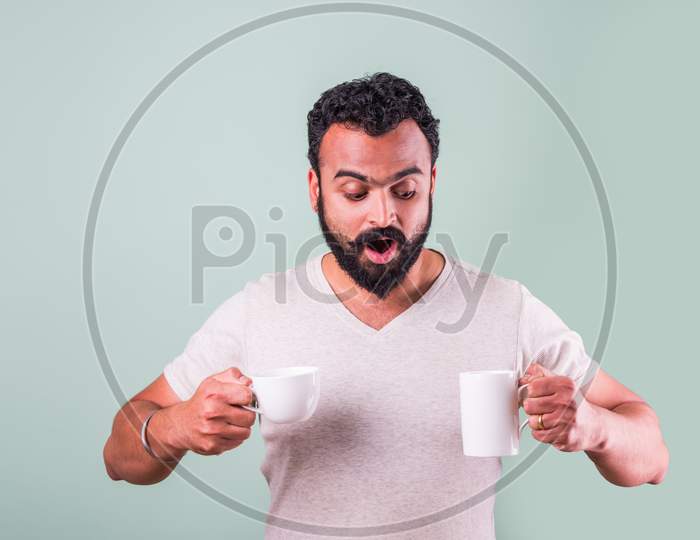 Indian Bearded young man drinking tea / coffee