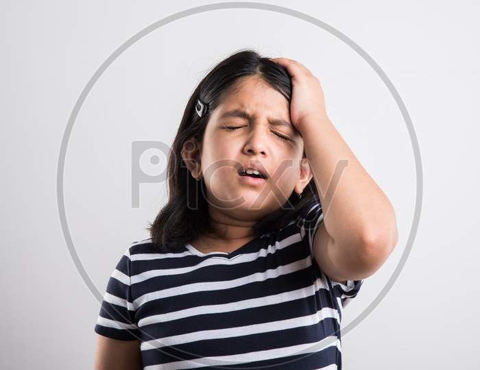 Cute little girl having headache or stressed
