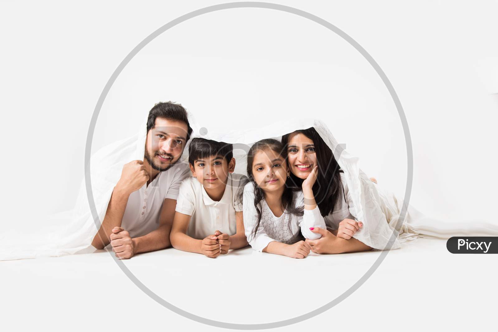 Young family of 4 standing over white