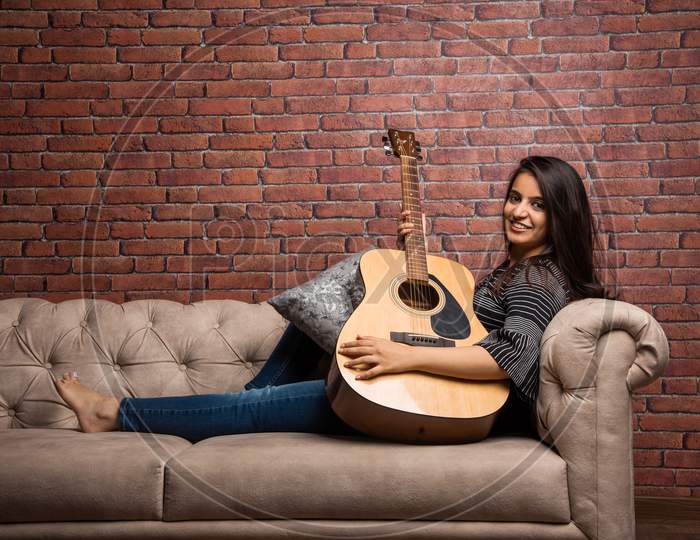 Attractive young girl with Guitar