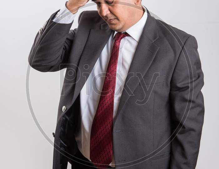 Indian handsome Businessman having headache