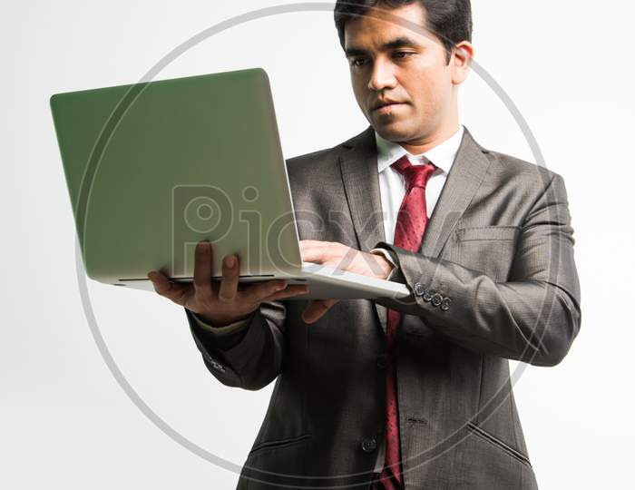 Indian young businessman with laptop computer