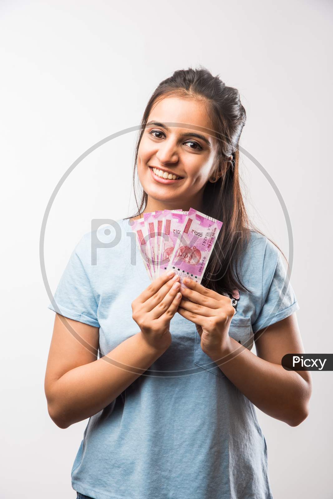 beautiful young girl holding money fan