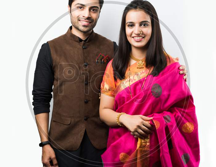 Indian couple in ethnic wear in namaskara pose or greeting