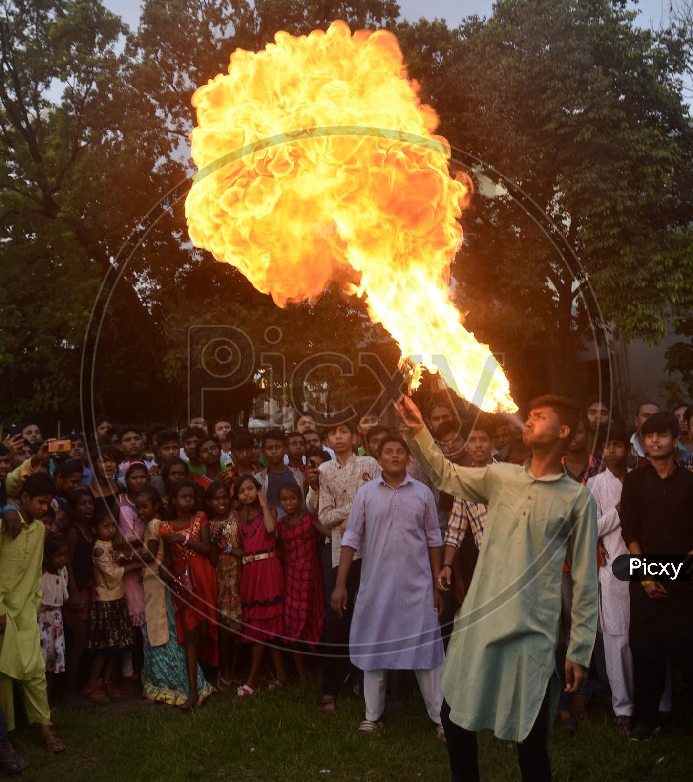 Fire eaters perform stunts on the occasion of Muharram during a procession