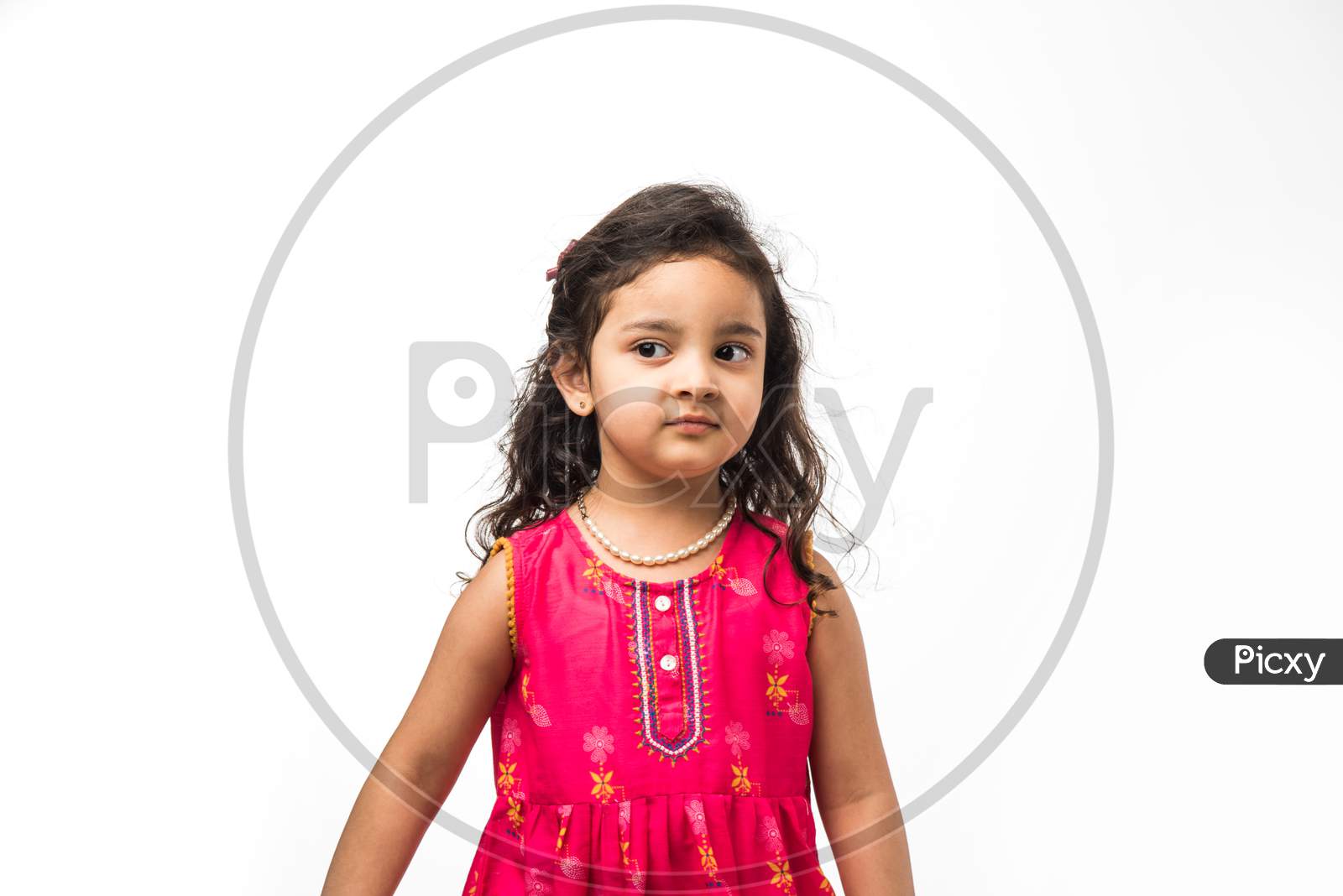 Portrait of cute little Indian girl model, standing isolated over white background