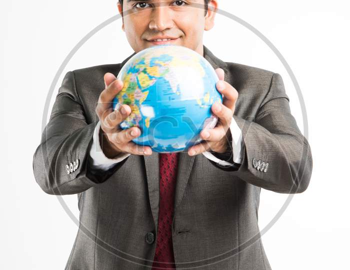 Indian young businessman with 3d model of globe