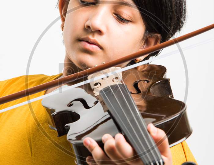 Small Girl playing violin over white background