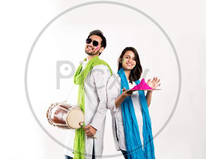 Young couple playing holi colours