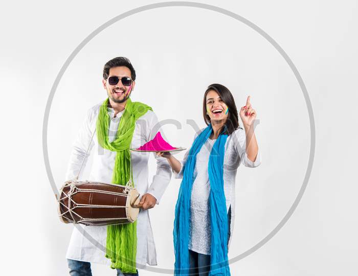 Young couple playing holi colours