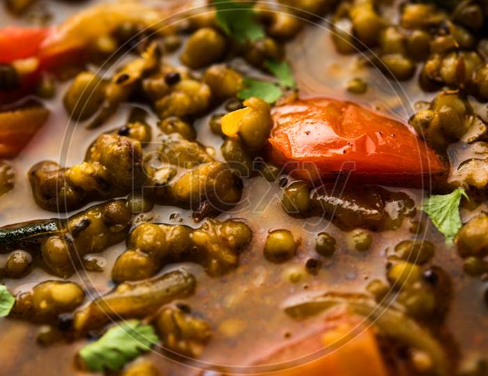 Whole Green Moong Dal fry / Whole Mung bean Tadka served in a bowl. selective focus