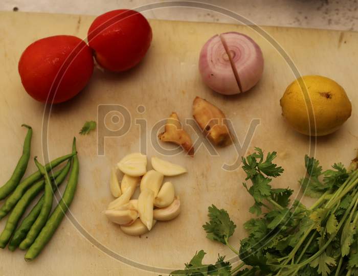 Making chutney with coriander, green chillies, garlic, Ginger, lemon, onion and some tomato